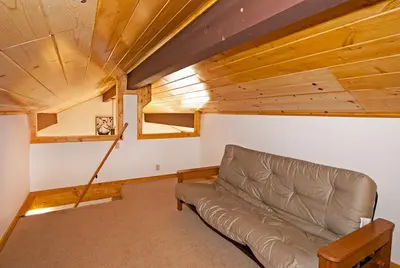 a leather couch in a room with a wooden ceiling at Valley View at Palisades -4 BR w Mountain Views, Pet-Friendly, and Close to Village in Olympic Valley