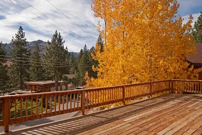 a wooden deck with a wooden fence and a tree at Valley View at Palisades -4 BR w Mountain Views, Pet-Friendly, and Close to Village in Olympic Valley