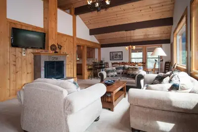 a large living room with couches and a fireplace at Valley View at Palisades -4 BR w Mountain Views, Pet-Friendly, and Close to Village in Olympic Valley