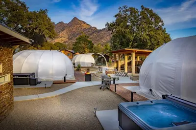 a group of domes with a hot tub in the foreground at Sequoia Studio Suites in Three Rivers