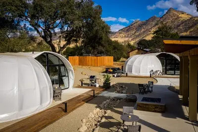 a group of tents with mountains in the background at Sequoia Studio Suites in Three Rivers