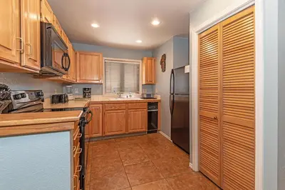 a kitchen with wooden cabinets and a stainless steel refrigerator at 226 McCloud great location in Incline Village