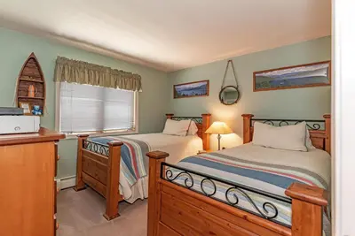 a bedroom with two beds and a desk and a window at 226 McCloud great location in Incline Village
