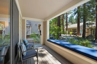 a porch with a bench and a large window at The perfect Forest Pines getaway in Incline Village