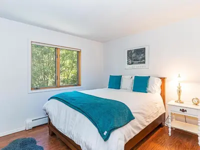 a bedroom with a bed with a blue blanket on it at 252 McCloud Upper level unit in Incline Village