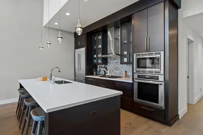 a kitchen with wooden cabinets and a white counter top at Appreciate this exclusive private penthouse located on Lake Tahoe in Crystal Bay