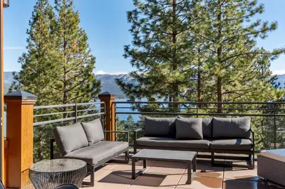 a patio with two couches and a table and chairs at Appreciate this exclusive private penthouse located on Lake Tahoe in Crystal Bay