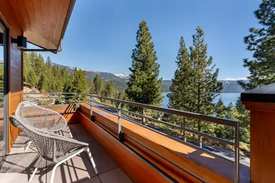 a balcony with two chairs and a view of the water at Appreciate this exclusive private penthouse located on Lake Tahoe in Crystal Bay