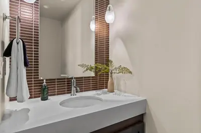 a bathroom with a sink and a mirror at Appreciate this exclusive private penthouse located on Lake Tahoe in Crystal Bay