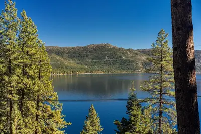 a view of a lake with trees in the foreground at Fabulous Views Of Lake Tahoe in Crystal Bay