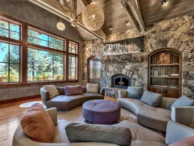a living room with couches and a stone wall at A Touch Of Tuscany In a Lake Tahoe Estate in Incline Village