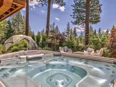 a hot tub in the middle of a yard with trees at A Touch Of Tuscany In a Lake Tahoe Estate in Incline Village