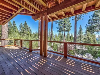 a deck with a view of the woods at A Touch Of Tuscany In a Lake Tahoe Estate in Incline Village