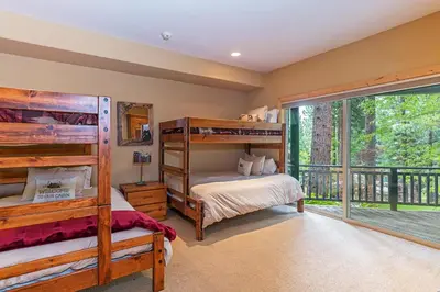 a bedroom with two bunk beds and a balcony at 585 Knotty Pine - Gorgoeous Moutain Home in Incline Village