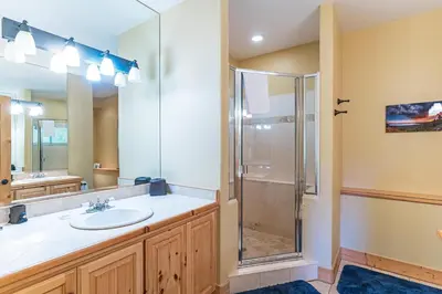 a bathroom with a sink and a shower at 585 Knotty Pine - Gorgoeous Moutain Home in Incline Village