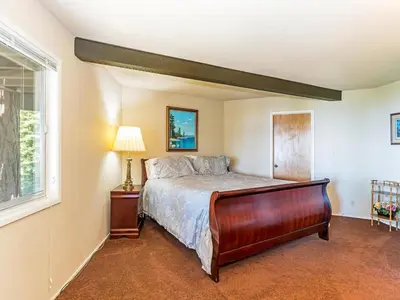 a bedroom with a bed and a window at Enjoy the brilliant views of Lake Tahoe from this mountainside Cabin in Incline Village
