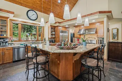 a kitchen with a large island with bar stools at Spectacular low elevation home at its finest! in Incline Village