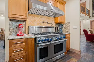 a kitchen with a stainless steel stove top oven at Spectacular low elevation home at its finest! in Incline Village