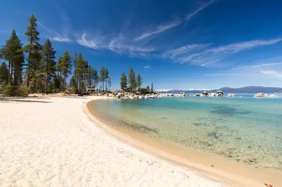 a view of a beach with trees and the water at Spectacular low elevation home at its finest! in Incline Village