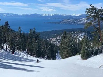 a person is skiing down a snow covered slope at Tranquil Tahoe A-Frame Walk to Beach in Tahoe Vista