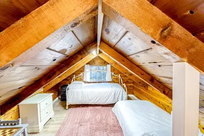 a bedroom with two beds in a attic at Casa nel Bosco in Arnold