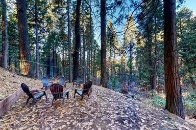 a group of chairs sitting around a table in the woods at Casa nel Bosco in Arnold