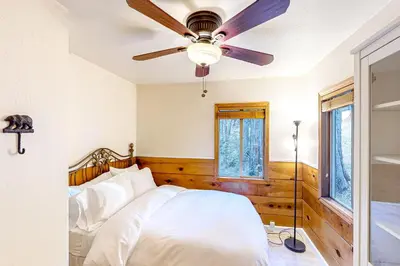 a bedroom with a bed with a ceiling fan at Casa nel Bosco in Arnold