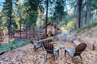 a group of chairs sitting in front of a cabin at Casa nel Bosco in Arnold