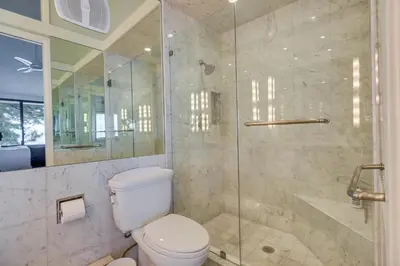 a bathroom with a toilet and a glass shower at Lake Tahoe Gem with Furnished Deck and Water Views! in Incline Village
