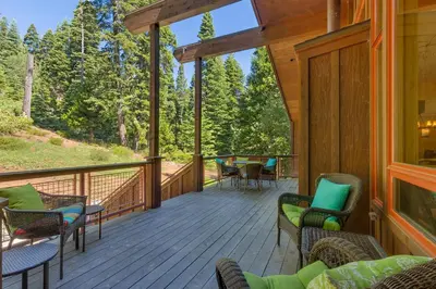 a screened porch with chairs and a table on it at Fairway Favorite - Walk to Tahoe City Shops, Dining & Lake - Pet Friendly in Tahoe City