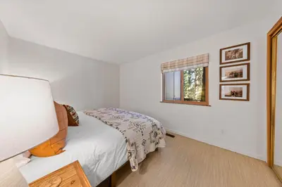 a bedroom with a bed and a window at Sleeping Bear Lodge- Remodeled 3BR Cabin- Fireplace- Ski Shuttle- Pet-Friendly in Truckee