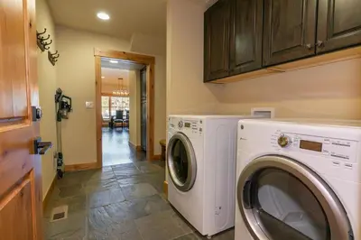 a laundry room with a washer and dryer at Trestlewood Lodge at Schaffers Mill - Gorgeous 3 BR w Golf Course Views - Extended Stays Welcome! in Truckee