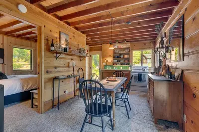 a kitchen and dining room with a table and chairs at Falcon's Rest - Ski and Summer Cabin in The Heart of North Lake Tahoe- Gas Fireplace in Carnelian Bay