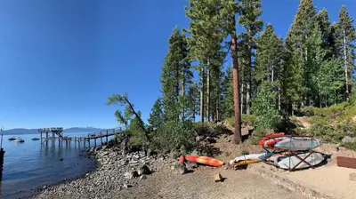a group of boats on a beach next to the water at Falcon's Rest - Ski and Summer Cabin in The Heart of North Lake Tahoe- Gas Fireplace in Carnelian Bay