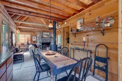 a dining room with a table and chairs in a cabin at Falcon's Rest - Ski and Summer Cabin in The Heart of North Lake Tahoe- Gas Fireplace in Carnelian Bay