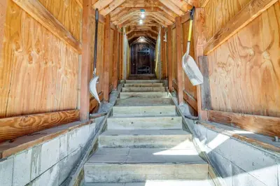 an empty train hallway with wooden walls and stairs at Serene Lakes Cabin with Deck Dog Friendly! in Soda Springs