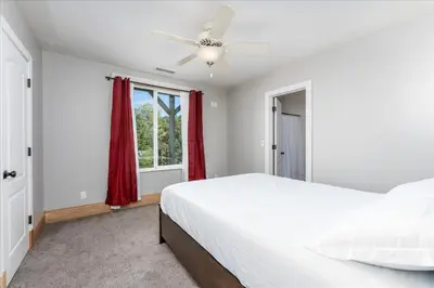 a bedroom with a bed and a ceiling fan at Yosemite Bass Lake VIEWS, 2 Homes, Games, Hot Tub in Coarsegold