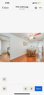 a living room with a table and a ceiling fan at Del Mar pool Home in Fresno