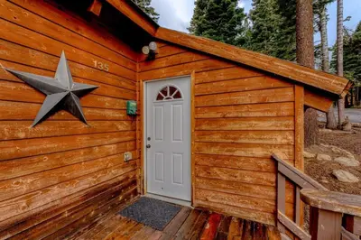 a wooden cabin with a star on the door at Stylish 3BR Near Trails w Hot Tub in Tahoe City