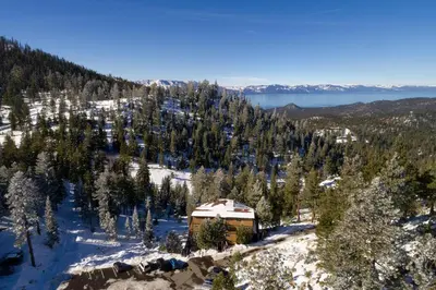 a cabin in the middle of a snow covered forest at Tall Pine Chalet in Stateline