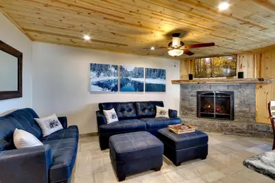 a living room with couches and a fireplace at Tall Pine Chalet in Stateline
