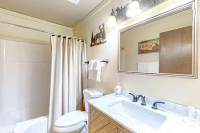 a bathroom with a sink and a toilet and a mirror at Kelly's Kastle in Incline Village