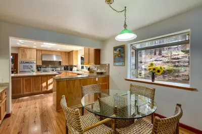 a kitchen with a glass table and chairs at Silver Rock Lodge in Zephyr Cove