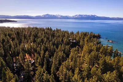 an aerial view of a forested island in a body of water at Silver Rock Lodge in Zephyr Cove