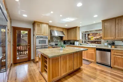 a kitchen with wooden cabinets and a large island at Silver Rock Lodge in Zephyr Cove