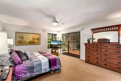 a bedroom with a bed and a dresser at Spacious Riverfront in South Lake Tahoe