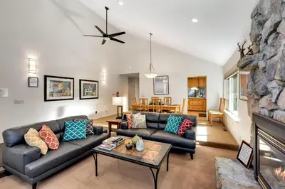 a living room with a couch and a fireplace at Spacious Riverfront in South Lake Tahoe