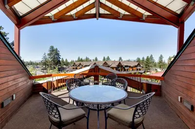 a patio with a table and chairs on a balcony at Downtown Penthouse in South Lake Tahoe