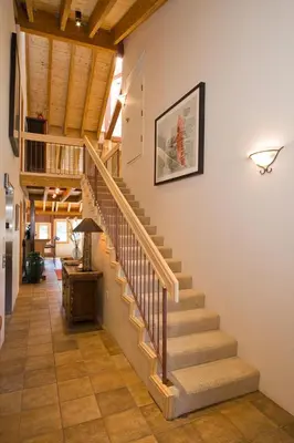 a staircase in a home with wooden ceilings at Downtown Penthouse in South Lake Tahoe