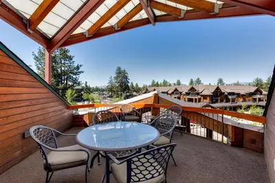 a patio with a table and chairs on a balcony at Downtown Penthouse in South Lake Tahoe